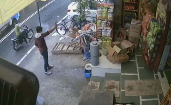 Man Caught Firing Outside Showroom Captured On CCTV - Sakshi