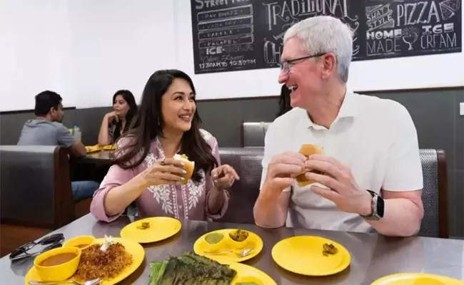 Actress Madhuri Dixit Had Shared A Picture Of Herself Eating Vada Pav With Tim Cook - Sakshi
