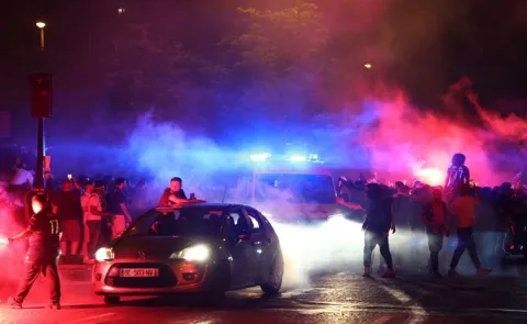 Two fans dead and police officer left in coma as violence erupts in Paris