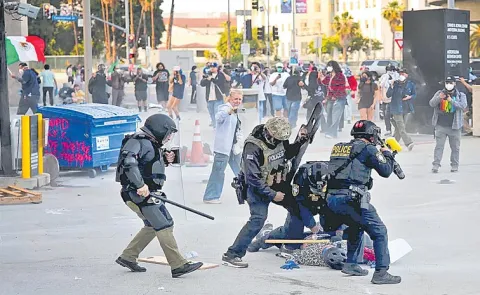 Riot police and protesters clash after Los Angeles immigration raids