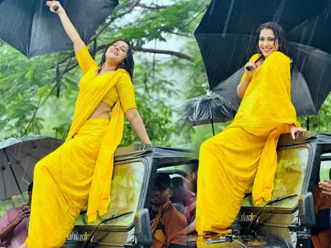 Anchor rashmi gautam looks gorgeous with yellow saree in rain photos