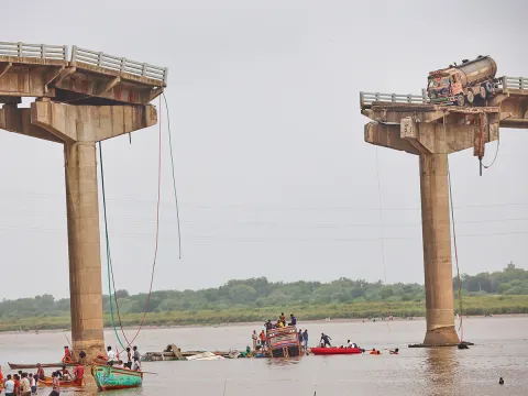 river following the collapse of a portion of a bridge in Mujpur near Vadodara