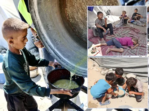 Palestinian boy receives the last drops of lentil soup at a food distribution point in Gaza