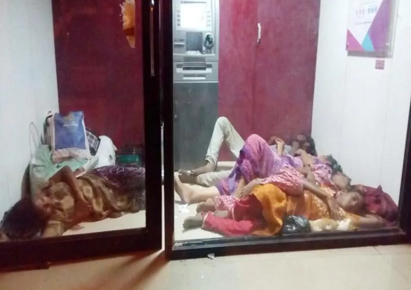 family sleeping in atm room at renigunta railway station - Sakshi