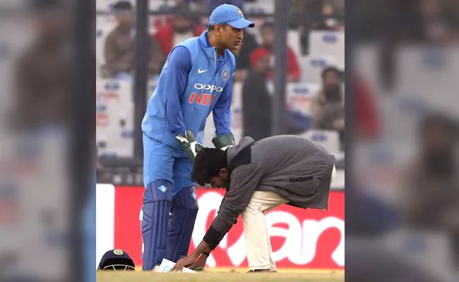 A fan touches the feet of Indias Mahendra Singh Dhoni - Sakshi