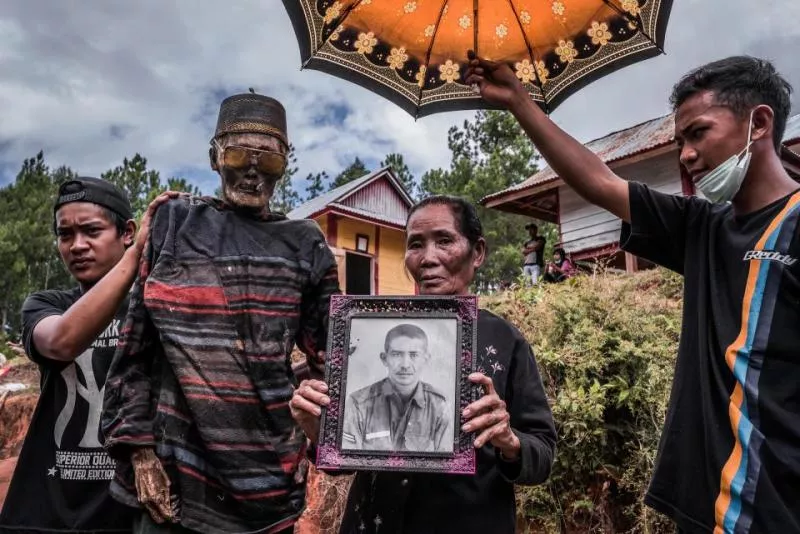 Indonesian villagers dig up their dead relatives and dress them up in eerie ritual - Sakshi