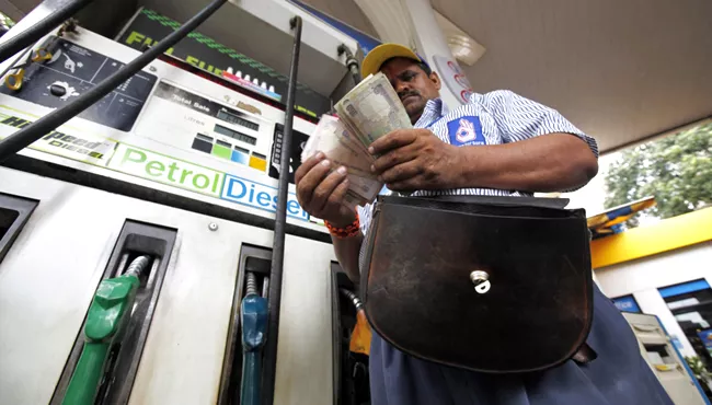 Government cuts excise duty on petrol and diesel by Rs 2 per liter - Sakshi