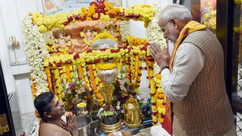 PM Narendra Modi prays at 125-year-old Shiva temple in Muscat - Sakshi