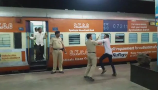 railway police attacks traveler in bangalore to kacheguda express - Sakshi