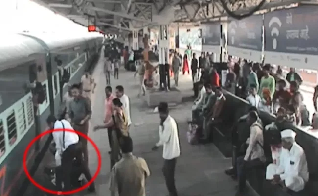 tte saves passenger from falling under moving train - Sakshi