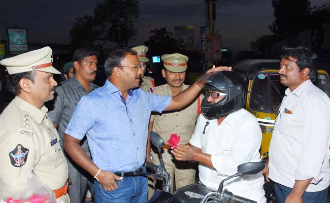 sp distribute rose flowers for helmet awareness - Sakshi