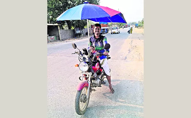 Umbrella Setting on Two Wheeler - Sakshi