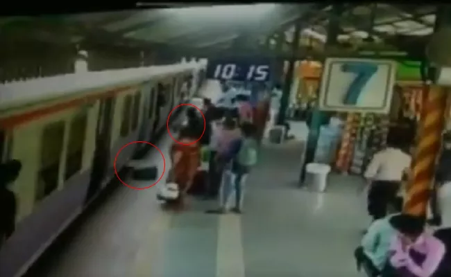 A Woman Nearly Fell Under Train While Trying To Pick Up Bag In Mumbai - Sakshi