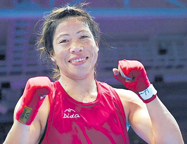 Mary Kom advances to semi-final to guarantee herself first CWG medal - Sakshi