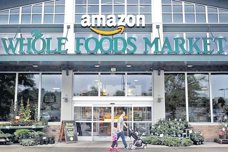 Amazon cuts Whole Foods prices for Prime members in new grocery - Sakshi