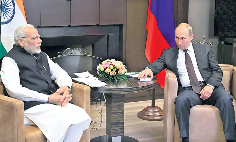 PM Narendra Modi meets Vladimir Putin in Sochi - Sakshi