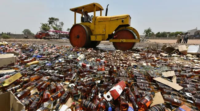 Gujarat Police Destroyed Liquor In Ahmedabad - Sakshi