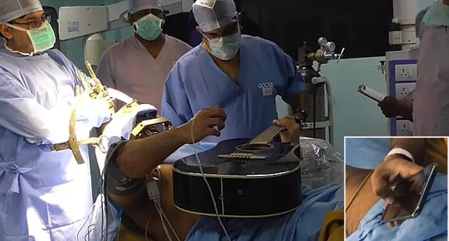 Patient Plays Guitar Uses Smartphone During Brain Surgery - Sakshi