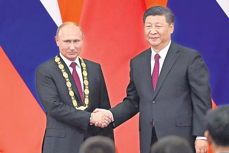 Xi Jinping honors Vladimir Putin with China's first-ever Friendship Medal - Sakshi