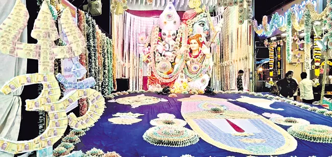 Ganesha Idol Decorated With One And Half Crore Currency Notes - Sakshi