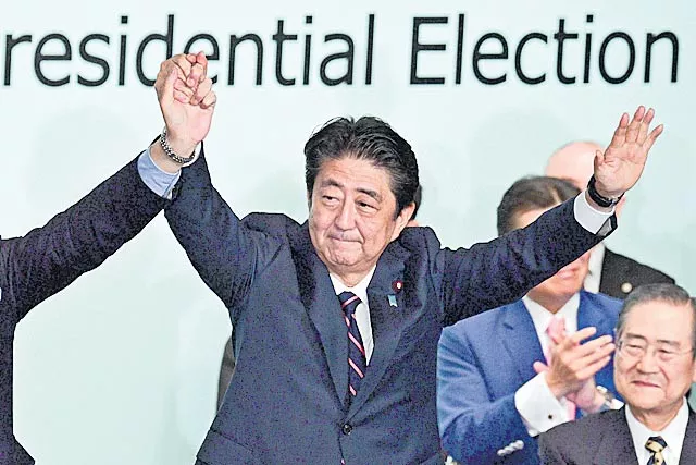 Japan's Abe re-elected as party head, to stay on as prime minister - Sakshi