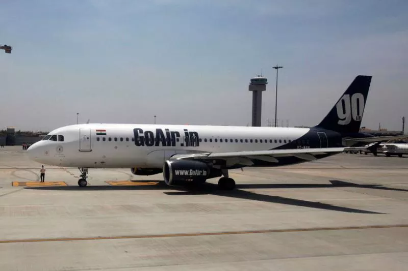 GoAir flyer Tried To Open The Exit Door While He Thought It Was Washroom Door - Sakshi