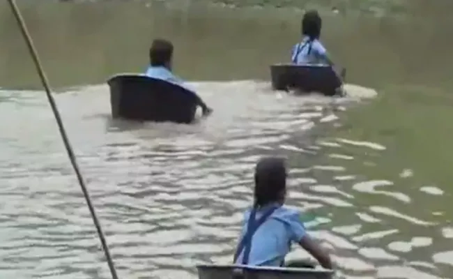 Children Cross River In Aluminium Pots To Reach School - Sakshi