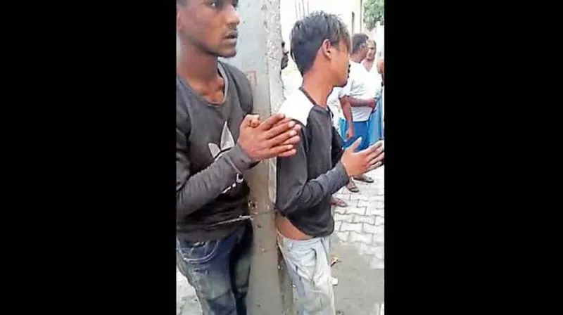 In Ghaziabad Two Men Tied To Electricity Pole Beaten For Stealing - Sakshi