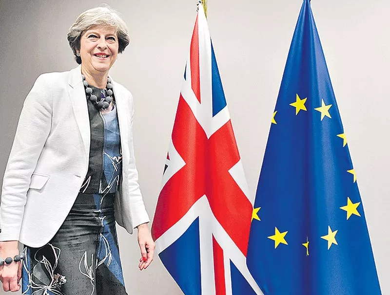 Theresa May to visit Brussels this week as she defends Brexit deal - Sakshi