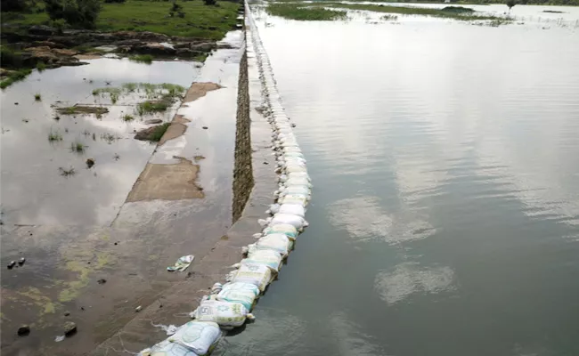 Crop Water Stops With Sand Bags in West Godavari - Sakshi