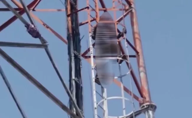 Youth Climbs Cell Phone Tower Demanding Pattadar Pass Book In Narsapur - Sakshi