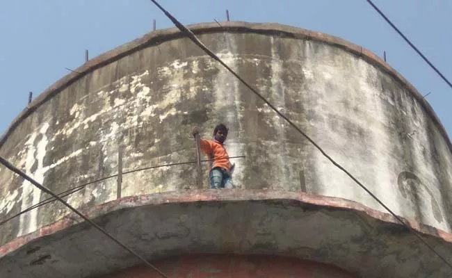 Youth Climb Up Water Tank Seeking Relatives Visiting - Sakshi