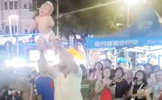 Russian Couple Seen Violently Swinging Their Baby Detained In Malaysia - Sakshi