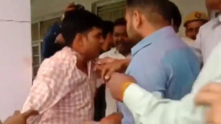 BJP Workers Beat Up Poll Officer In Moradabad - Sakshi