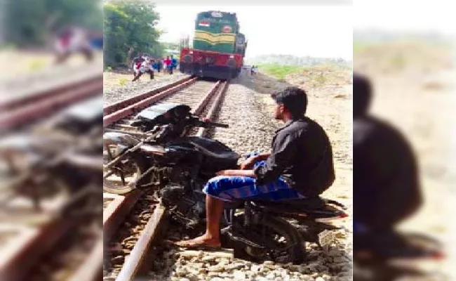 Young Man Arrest in Bike Stands on Train Track in Tamil Nadu - Sakshi