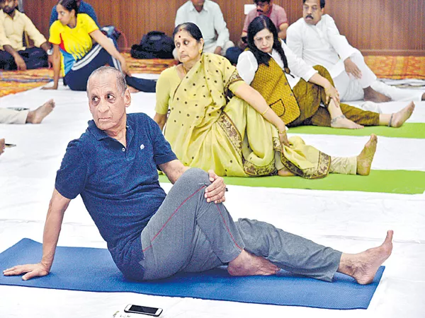 Governor couple participating in yoga celebrations - Sakshi