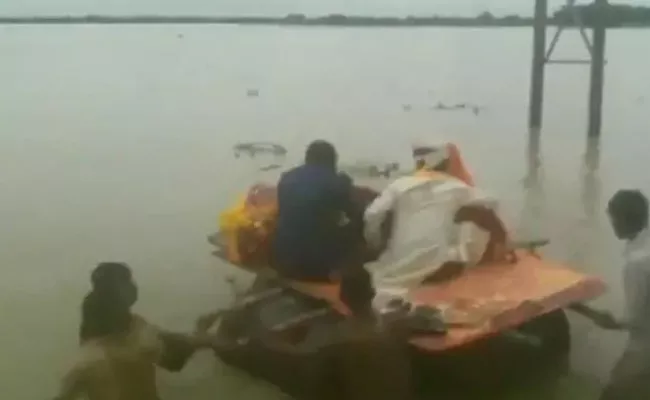 Newly Married Couple Cross Flooded Road - Sakshi