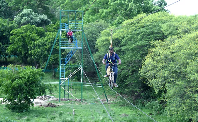 A Bycyle Riding On Rope Was Arranged In Harithavanam, Adilabad - Sakshi