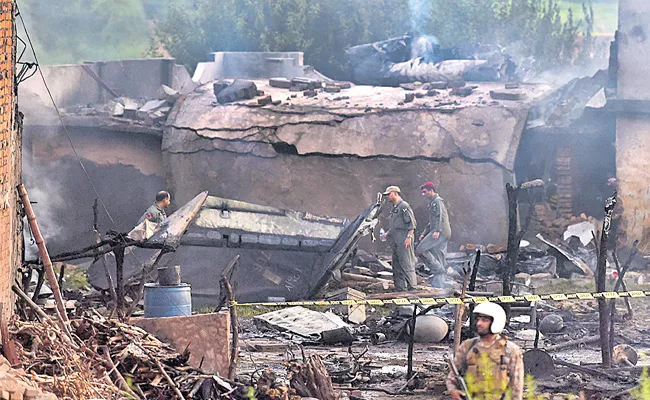 Pakistan Army Plane Crashes Into Residential Area - Sakshi