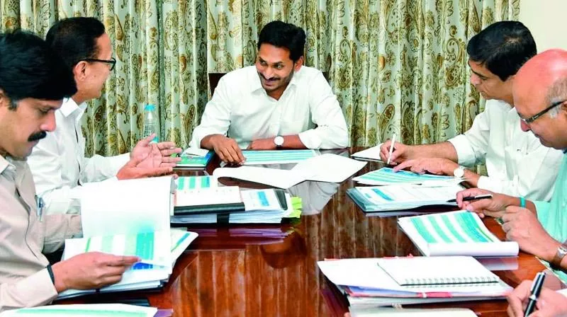 Jagan Mohan Reddy asks babus to give priority to Navaratnalu - Sakshi