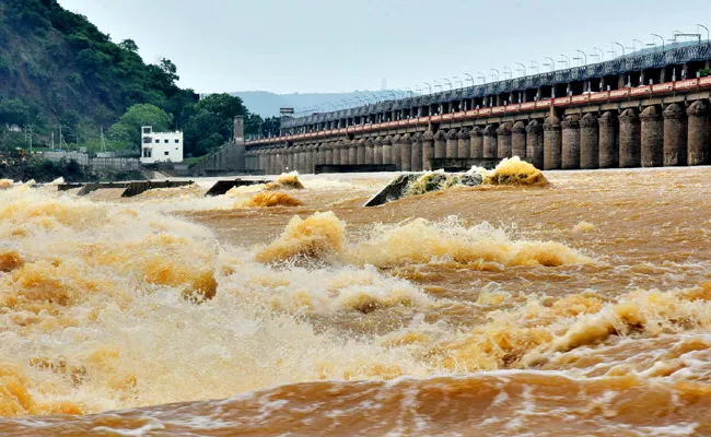 Heavy Flood Reached To Prakasam Barrage Water Release To Down - Sakshi