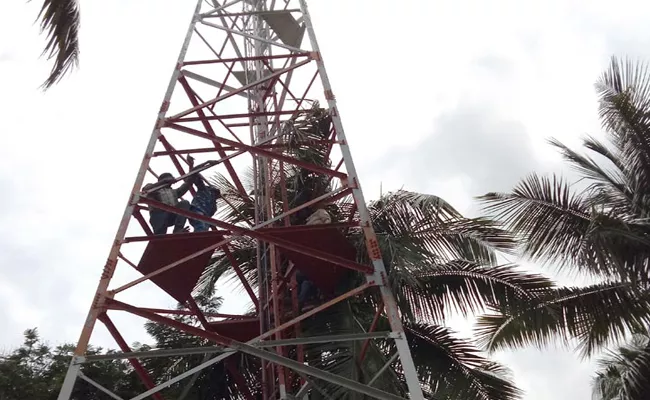 5 Dalit Youngs Protest By Climbing Signal Tower In East Godavari Over Remove Ambedkar Statue   - Sakshi