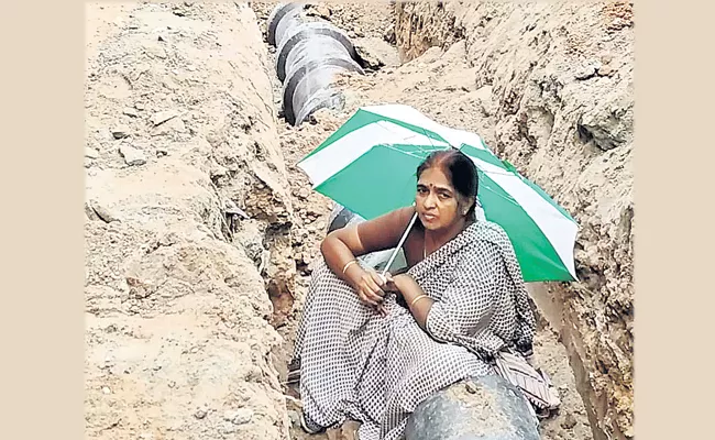 Woman Protest Sitting In Drainage At Madhapur In Hyderabad - Sakshi