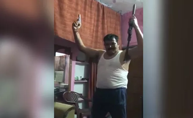 Probe Ordered After Video Shows Man Dancing With Two Guns - Sakshi