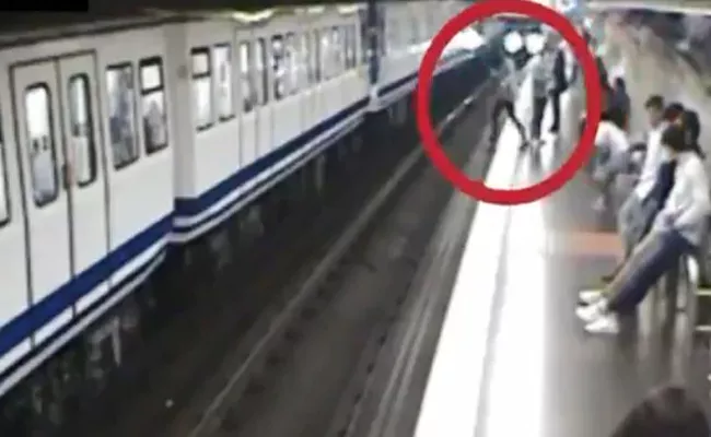 Woman Busy On Phone And Falling In Front Of Train - Sakshi