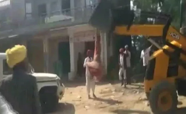 Rajasthan Lady Sarpanch Climbs On JCB Machine Over Anti Encroachment Drive - Sakshi