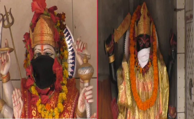 Varanasi Temple Priest Puts Anti Pollution Mask On Deities - Sakshi