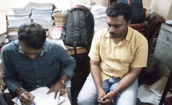 VRO Caught For Taking Bribe - Sakshi