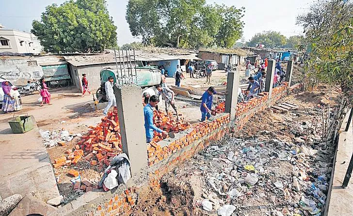 Walls rise in Ahmedabad ahead of Donald Trump visit Area - Sakshi