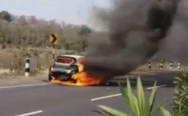 Car Met With Fire Accident Near Neradigonda Toll Gate - Sakshi